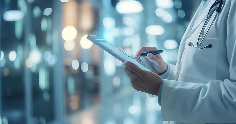 Nurse inputting patient information into an EHR system